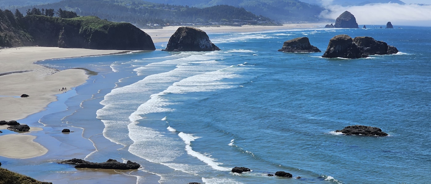 Lincoln City Oregon beach with mountains in the background